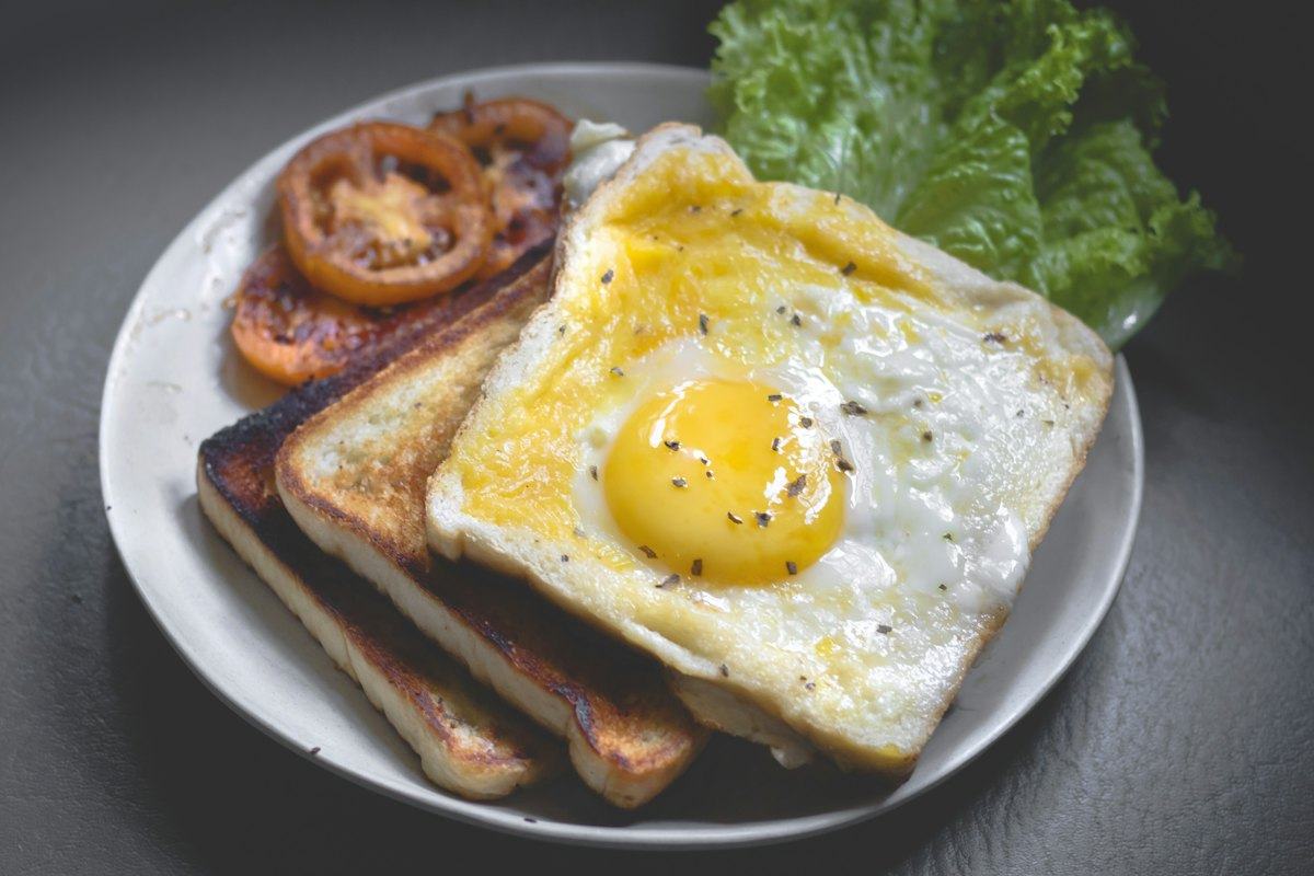 Fried egg on toast with breakfast sides
