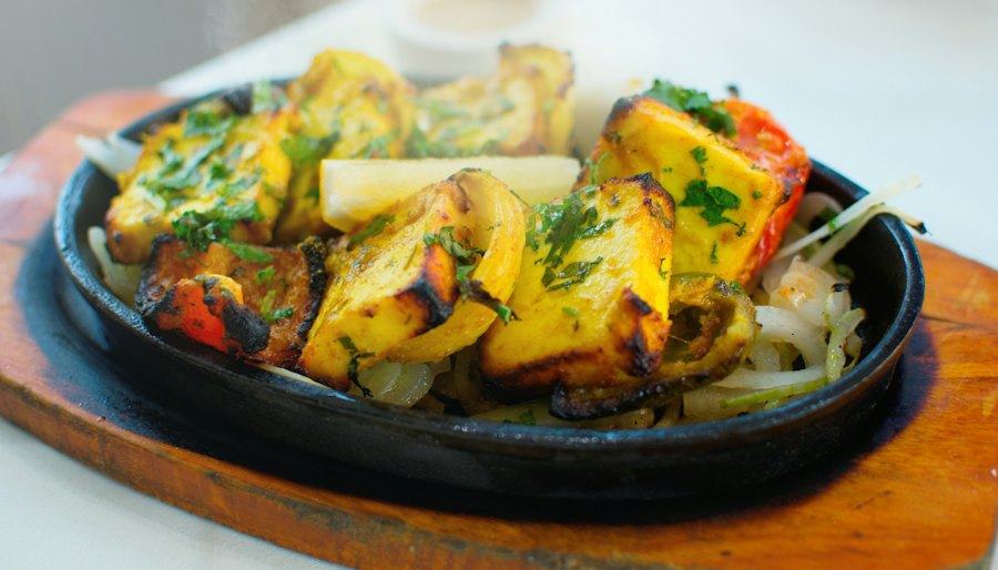 Grilled paneer and peppers on a sizzling plate